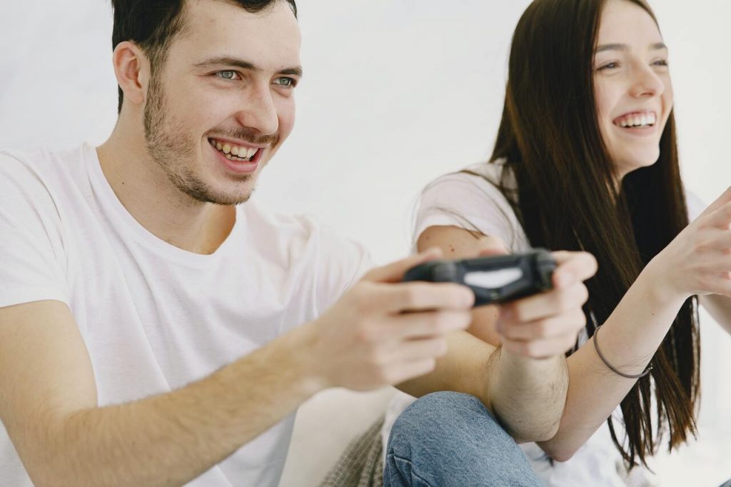 Couple souriant s'adonnant aux jeux vidéo