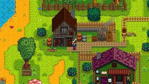 Capture d'écran du jeu Stardew Valley. Les graphismes sont en pixels avec des couleurs acidulées. Le personnage du joueur est devant la forge du village. On devine que l'autre bâtiment présent sur l'image est une bibliothèque.
